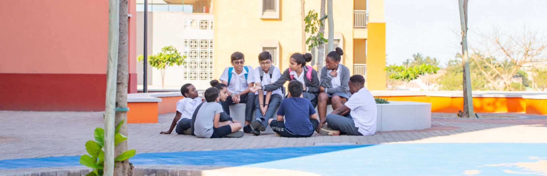 Students sitting together in a group outside of the classroom.
