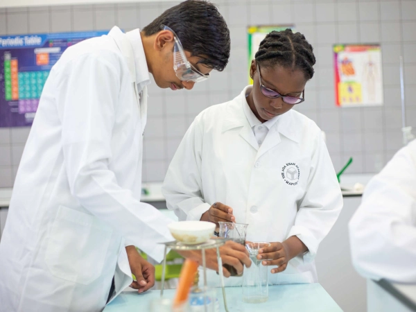 An AKA Maputo teacher and student working together inside a classroom.