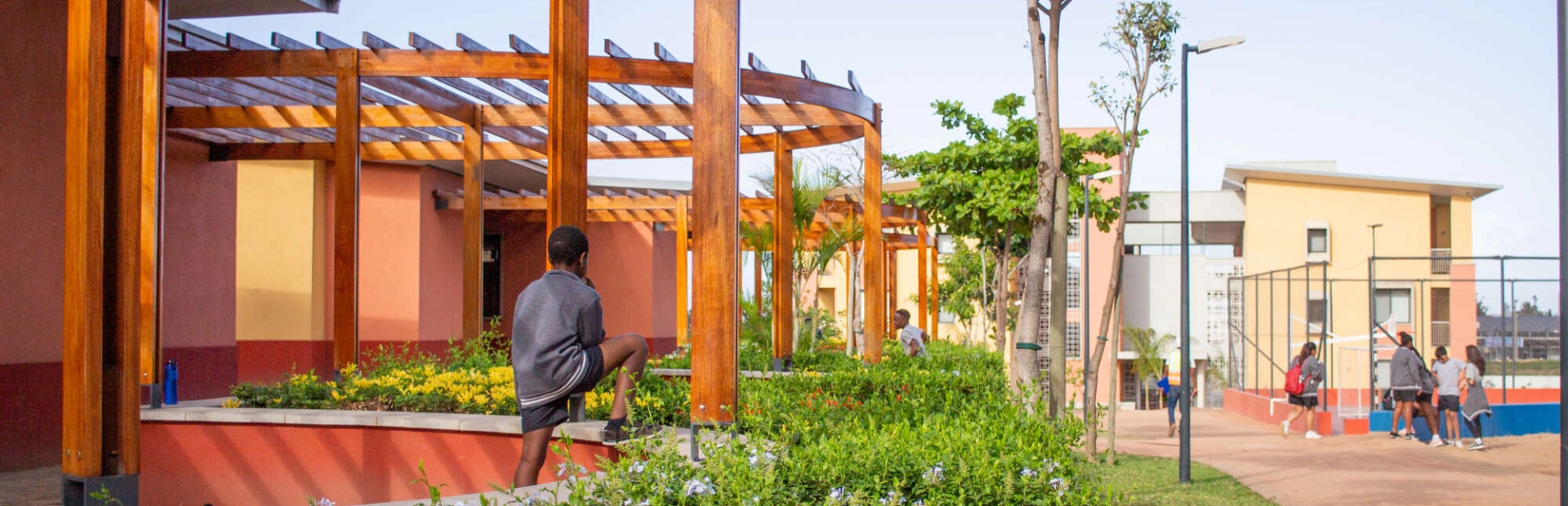 An AKA Maputo student standing outside.