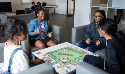 Students playing a game with each other inside the residential common room at AKA Maputo.