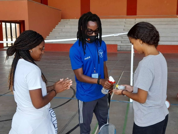 Elves Tembe, a Physical Health and Education Teacher at AKA Maputo, helping students sanitise sports equipment. 