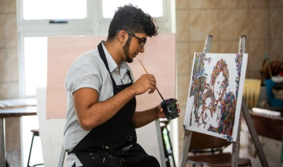 DP student painting in the art room.