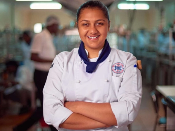 Junior School student with teacher beside her.