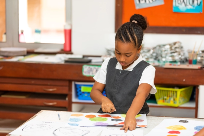 AKA Mombasa student playing a musical instrument.