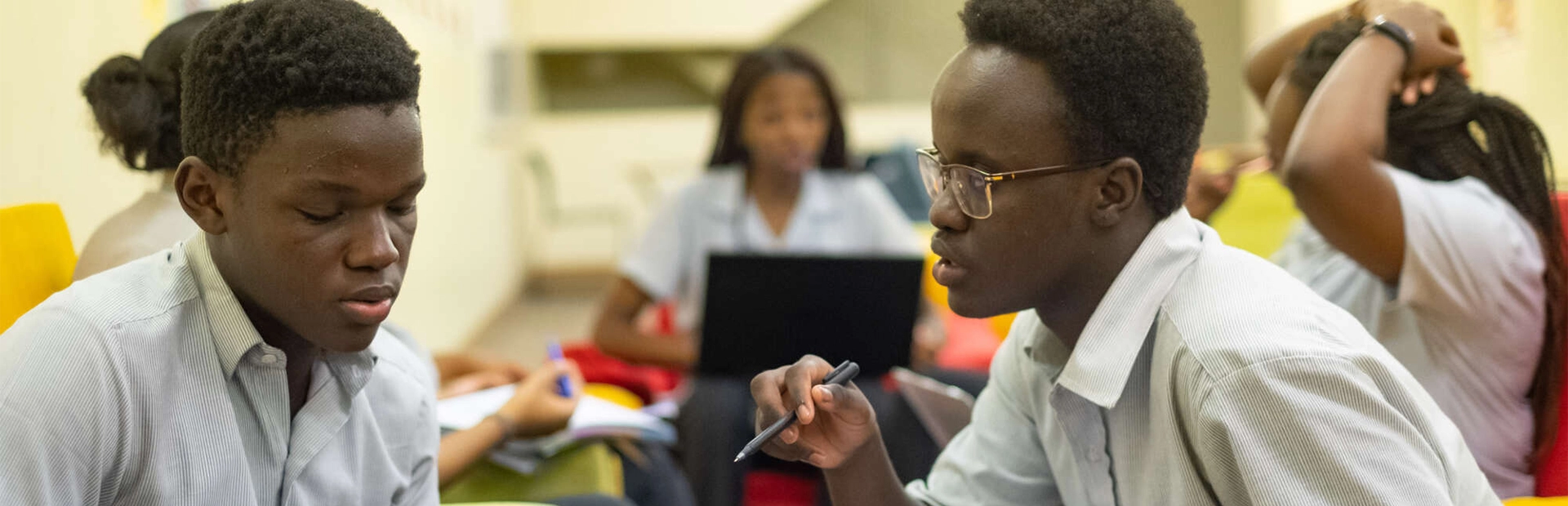 Students sitting on couches and studying.