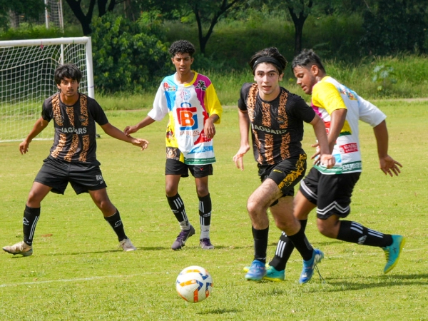 Residential students and dorm parent sitting outside the dorms.