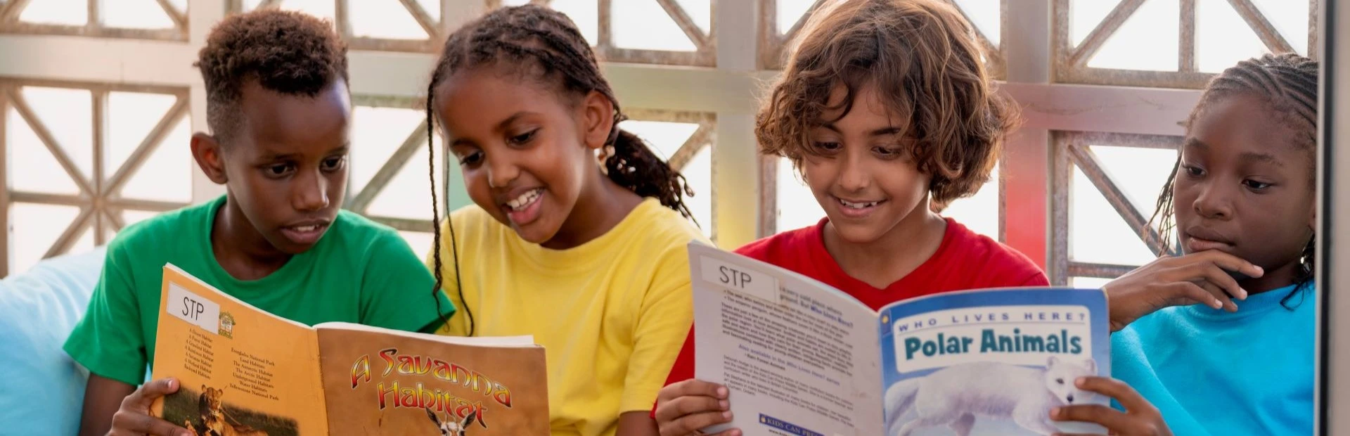  Four students sitting and reading together: