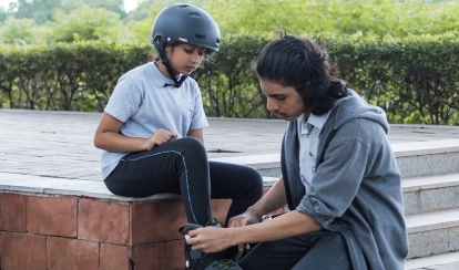 A student supporting a junior.