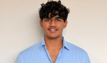  AKA Hyderabad students and young children sit around tables in an outdoor learning area, engaged in an educational activity.