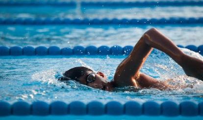 Student swimming competitively.