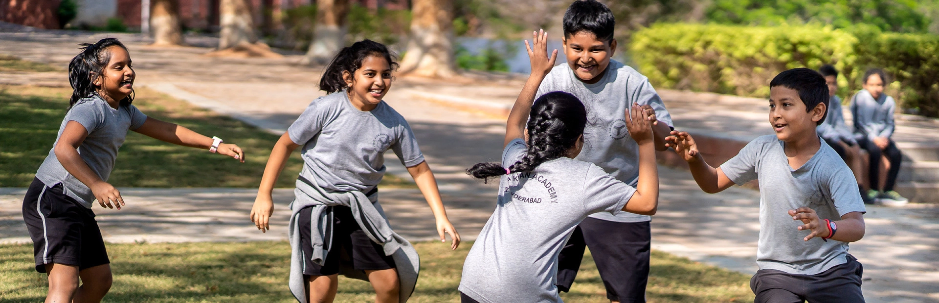 Students playing in grass.