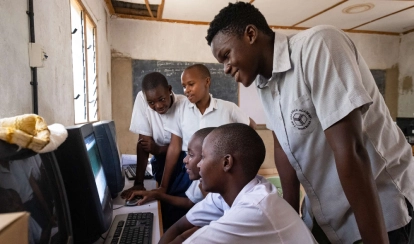 Raphael with students in a computer lab.