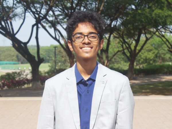 Two students at AKA Dhaka focused on painting and colouring artwork during art class.