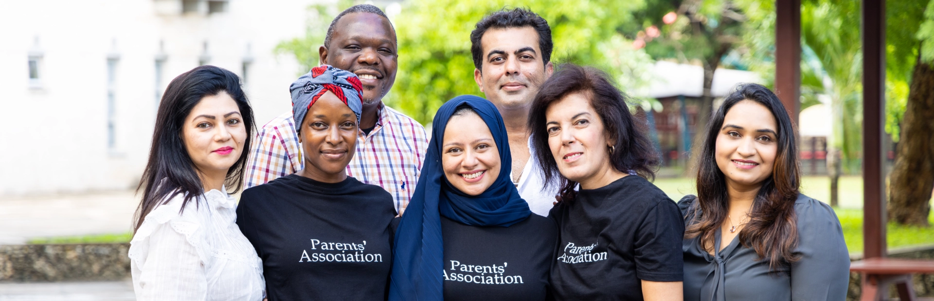  Members of the parents association standing in a group at the gazebos.