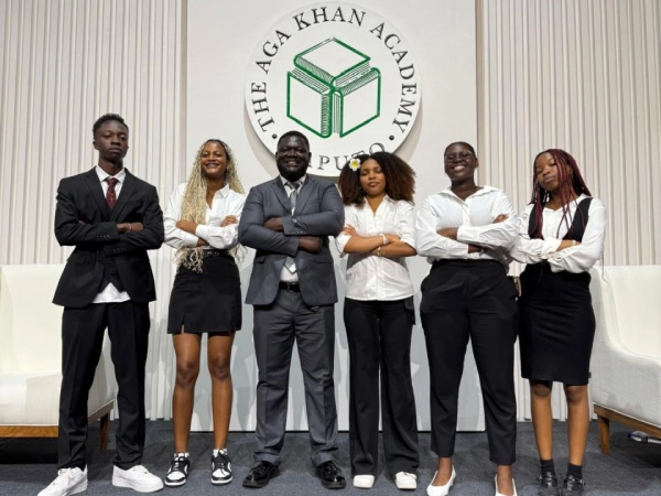 Ana poses with her teacher and classmates after the graduation ceremony