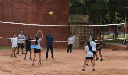 Students playing volleyball.